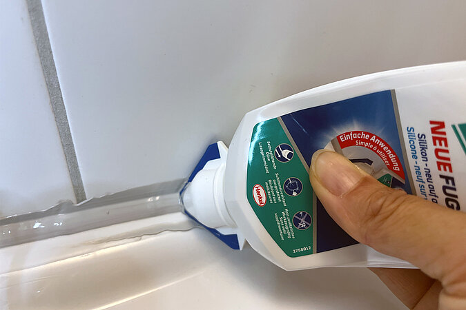 Neue Fuge direkt auf die alte Dichtmasse auftragen, um Silikonfugen aufzufrischen und das Waschbecken neu abzudichten.